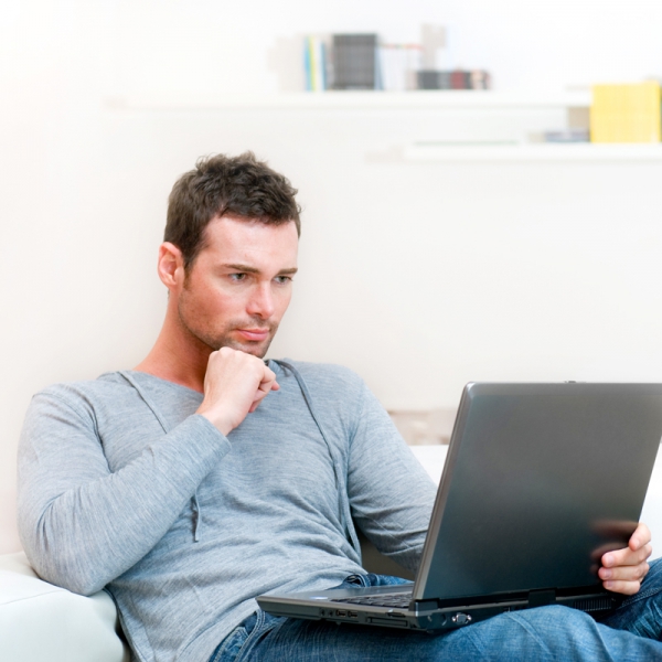 photo of a man working on a laptop computer